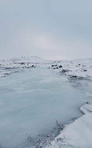 Frozen lake in a winter snowy landscape
